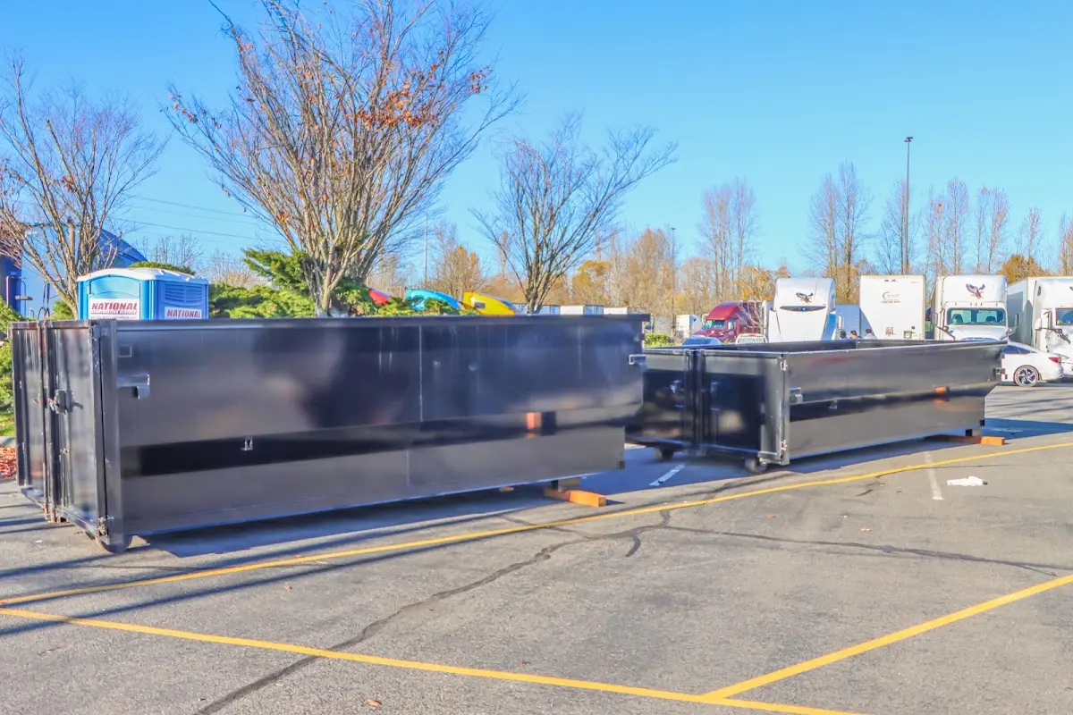 Professional dumpster rental service with roll-off container on residential driveway in Wenatchee